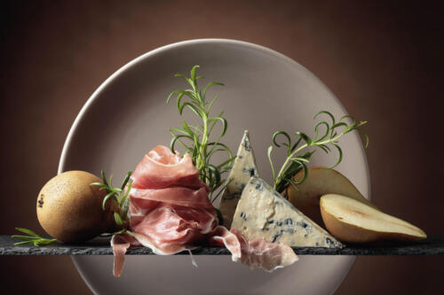 Prosciutto or spanish jamon with blue cheese, pears and rosemary.